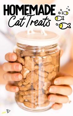 someone holding a jar full of cat treats with the words homemade cat treats in it