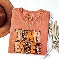 Capture the spirit of the Tennessee State with this Retro Tennessee Shirt. Perfect for fans of nostalgia, this Nostalgic Tennessee T-Shirt features a timeless design that showcases your love for Tennessee in a stylish and comfortable way. Whether you're gearing up for game day, exploring the scenic beauty of Tennessee, or showing off your school pride, this Tennessee Game Day Shirt is a must-have. It's an ideal Tennessee Travel Gift for college students, alumni, and fans of the University. Celeb Retro Cotton T-shirt For Fan Gear, Band Merch Cotton T-shirt For Fans, Casual T-shirt With Lettering For Fans, College Cotton T-shirt With Lettering, College Fan Apparel T-shirt With Lettering, Cotton Tops With Lettering For Game Day, Cotton Tops With Lettering For School Spirit, Cotton Tops With Team Spirit Lettering, Band Merch Cotton T-shirt For College