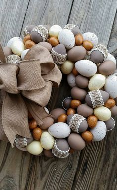 a wreath made out of eggs and burlocks on top of a wooden table