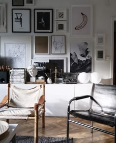 a living room filled with furniture and pictures on the wall