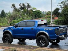 a blue pick up truck parked on the street