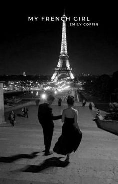 a man and woman standing in front of the eiffel tower, at night