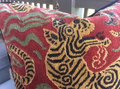 a close up of a decorative pillow on a chair