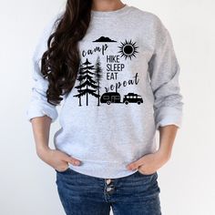 "This is a camping sweatshirt for a nature and adventure lover featuring camping graphics and funny saying Camp Hike Sleep Eat Repeat. Great Gift for any camper. Ideal for any situation, a unisex heavy blend crewneck sweatshirt is pure comfort. These garments are made from polyester and cotton. This combination helps designs come out looking fresh and beautiful. The collar is ribbed knit, so it retains its shape even after washing. There are no itchy side seams on these sweaters.  .: 50% cotton, 50% polyester .: Medium-heavy fabric (8.0 oz/yd² (271.25 g/m .: Loose fit .: Sewn-in label .: Runs true to size HOW TO ORDER: 1.Choose your unisex sweatshirt size, refer to the Size Chart 2.Choose sweatshirt color from the drop downs. 3.Complete this process for every additional item you decide to Casual Outdoor Sweatshirt With Screen Print, Casual Outdoor Screen Print Sweatshirt, Outdoor Cotton Sweatshirt, Long Sleeve T-shirt With Letter Print For Camping, Relaxed Fit Graphic Sweatshirt For Camping, Relaxed Fit Letter Print Sweatshirt For Outdoor, Camping Sweatshirt, Camper Shirt, Funny Camping