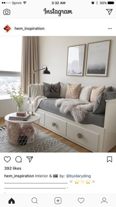 an instagramted photo of a living room with grey couches and white coffee table