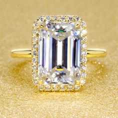 The Adara, 5.5ct Elongated Emerald-cut Halo Ring | Earthena Jewelry Emerald Cut Halo Ring, Emerald Cut Halo, Emerald Cut Diamond Engagement Ring, Emerald Cut Diamond Engagement, Classic Romance, Basket Setting, Solid Gold Band, Classic Engagement Rings, Jewelry Ring Box