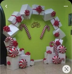 a christmas wreath made out of boxes and candy canes