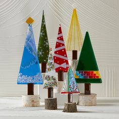 small christmas trees made out of wood are on display