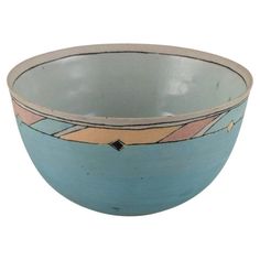 a blue bowl with an abstract design on the rim and bottom, sitting in front of a white background