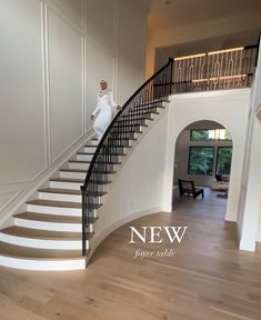 there is a woman standing on the stairs in front of a staircase that has been painted white