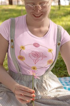 Need more whimsical cottagecore in your wardrobe? Pick up this rose embroidery-esque tee! What's better than a soft, light cotton, quality t-shirt in your wardrobe? This comfy, contoured 100% cotton tee offers a semi-fitted silhouette and is pre-shrunk to ensure it stays a staple for longer. It features cap sleeves and a taped neck and shoulders. *Not actual embroidery. Embroidery-esque design. Medium fabric (5.3 oz/yd² (180 g/m 100% cotton (fiber content may vary for different colors) Tear-away label Semi-fitted                             S     M    L             XL 2XL 3XL Width, in 17.25 19.25 21.25 23.27 25.25 27.25 Height, in 25.51 26.00 27.00 28.00 28.50 29.00 Spring Rose Print Short Sleeve T-shirt, Spring Cotton T-shirt With Rose Print, Cottagecore Floral Embroidery T-shirt For Summer, Cottagecore Floral Embroidered T-shirt For Summer, Pink T-shirt With Floral Embroidery And Short Sleeves, Summer Pink T-shirt With Floral Embroidery, Pink Short Sleeve Cottagecore Top, Casual Rose Cotton Top, Cottagecore Tshirt