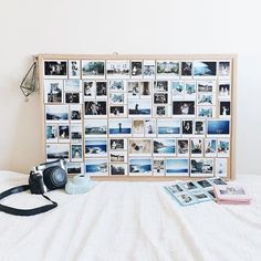 a white bed topped with pictures and a camera