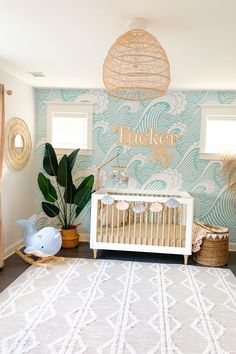 a baby's room decorated in blue and white