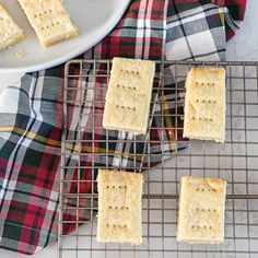 crackers cooling on a wire rack next to a white plate and plaid napkins