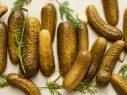 cucumbers with dill and garlic on a white surface