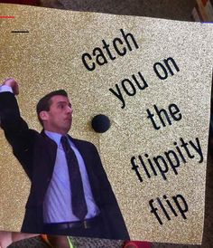 a man in a suit and tie holding up a sign that says catch you on the flippy flip