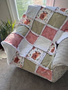 a couch covered in a blanket sitting on top of a carpeted floor next to a window