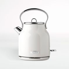 a white tea kettle sitting on top of a table