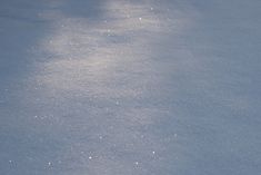 snow covered ground with small white dots on the top and bottom, as seen from above