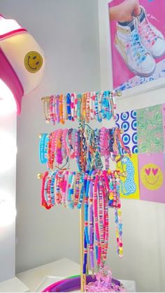 a bunch of bracelets that are hanging on a rack in the corner of a room