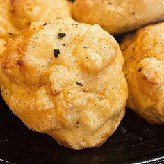 some food is on a black plate and it looks like they have been cooked in the oven