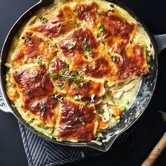 a skillet filled with lasagna casserole on top of a table