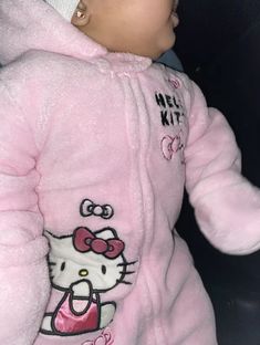 a baby in a pink hello kitty outfit