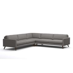 a gray sectional couch with wooden legs on an isolated white background