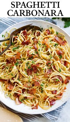 a plate of pasta with bacon, parmesan and parsley on the side