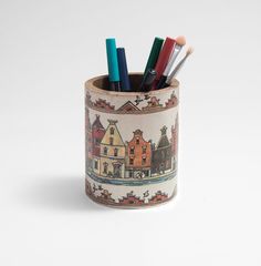 four pencils in a cup with houses on it