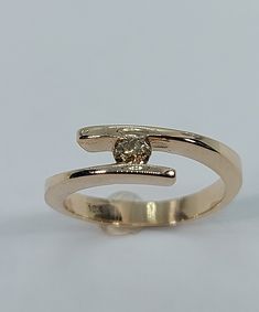 This handmade, beautiful  ring has been expertly crafted in warm 10k yellow gold and authentic Champagne diamonds. This gorgeous ring will make a great any occasion/Christmas gift. All of my jewelry is handmade from scratch, one item at a time as I like to make sure I am producing a high quality piece. Upon request a personalized message can be added to the inside of the ring. A tracking shipping number will be provided to you once the ring has been shipped. Diamonds measurements: 1 Diamonds: 3. 14k Gold Polished Bypass Ring, 14k Gold Bypass Ring With Polished Finish, Formal Yellow Gold Bypass Ring With Tension Setting, Formal 14k Gold Bypass Ring With Tension Setting, Polished Yellow Gold Bypass Ring, Yellow Gold Bypass Ring With Polished Finish, Gold Solitaire Ring With Open Band, Gold Bypass Ring For Formal Occasions, Formal Gold Bypass Ring With Brilliant Cut