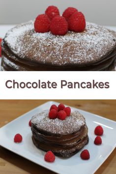 chocolate pancakes topped with raspberries and powdered sugar are on a white plate