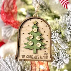 a wooden ornament hanging from a christmas tree with the words, the gonzales family on it