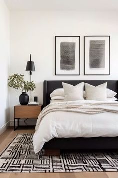 a bedroom with two framed pictures above the bed