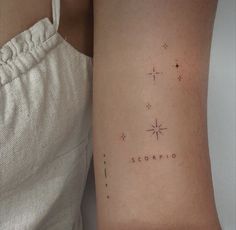 a woman's arm with the word scorpio written in cursive writing