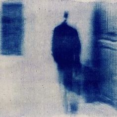 a blurry image of a man walking down the street