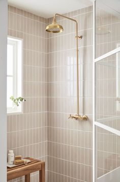 a bathroom with tiled walls and a shower head