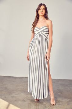 Introducing our Stripe Print Tube Maxi Dress, a chic and timeless addition to your wardrobe. This maxi dress features a classic stripe print that exudes sophistication and a touch of nautical charm. The tube-style design is both elegant and comfortable, making it perfect for warm-weather occasions. With its flattering fit and fashionable print, it's ideal for a variety of outings. Size + Fit- Model is wearing size S- Measurements taken from size S- 5'9" / 175CM- 32-24-34 Style: Chic Print / Pattern: Stripe Print Silhouette: Maxi Dress Fit: Relaxed Embellishment: Slit Neck Line: Tube Sleeve: Sleeveless Length: Maxi Closure: Smocked Lining: Yes Made In: CHINAFabric Contents: Self: 100% Rayon, Lining 1: 100% Rayon, Lining 2: 100% Polyester Non-stretch fabric Non-sheer fabric Care Instructions Tube Maxi Dress, Tube Maxi Dresses, Vertical Design, Halter Mini Dress, Striped Maxi, Striped Maxi Dresses, Woven Dress, Tube Dress, White Maxi Dresses