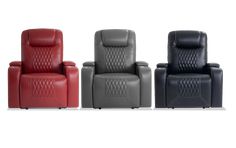 three different colored recliners sitting next to each other