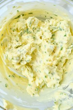 a glass bowl filled with mashed potatoes on top of a table