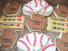 decorated cookies in the shape of baseball mitts and gloves with names on each cookie