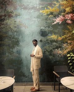 a man standing in front of a painting