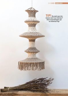 the cover of an article about art and crafts, featuring three tiered objects with fringes hanging from them