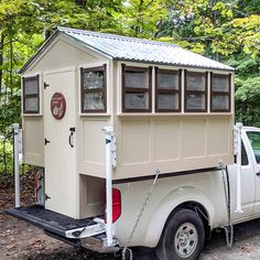 a white truck with a small house on the back