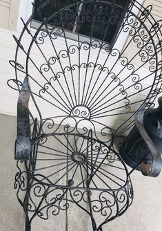 an iron fan sitting on the side of a building next to a door and window