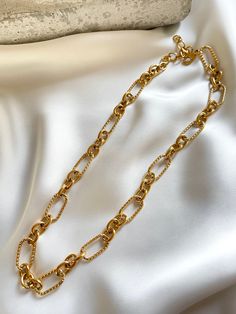 Stunning 18k gold plated chain woman necklace. Statment jewellery piece with mixed texture link designs. Made to wear it comfortably with any clothing materials. You can easily style it with every outfit day or evening, casual or occasional. Perfect piece to elevate your look! Made with most durable stainless steel material. So you could enjoy our creations for longest time. M E A S U R E M E N T S Length = 40cm + 5cm adjustable extension. Width = 11cm. C A R E T I P S ✔️ Please remove jewelry before showering, swimming and sleeping. ✔️Avoid direct use of perfumes, lotions or other harsh chemicals on the item. ✔️Store in a cool dry place, ideally in a separate compartments to prevent scratching. ✔️Gently wipe jewelry with a polishing cloth to clean and maintain shine. Why jewelry is made f Trendy Gold Plated Chain Necklace, Trendy Gold-tone Link Necklace, Trendy Gold Plated Paperclip Chain Necklace, Trendy Gold Chain Link Necklace, Trendy Gold-tone Link Chain Necklace, Trendy Gold Oval Link Necklace, Trendy Chunky Chain Link Necklace, Trendy Chunky Chain Necklace, Gold Plated Chunky Chain Necklace For Everyday