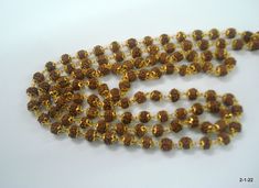 "20kt gold and rudraksha beads chain necklace mala (108+1=109 Beads) from rajasthan india. great handmade chain, good for jewellery collection. Note - Please check pictures carefully for more details. Length - 102 cm(40.2\") we can adjust the length. Thickness - 6/6.5 mm gross weight approx - 29.5 grams gold weight approx - 20 grams Material - 20kt yellow gold & rudraksha beads." Gold Mala With 8mm Beads For Meditation, Gold Hand-strung Mala For Meditation, Gold Mala With 108 Beads For Meditation, Gold 108 Beads Mala For Meditation, Handmade Gold Temple Jewelry Mala, Gold Mala With 108 Beads For Rituals, Gold Mala With 108 Beads As Gift, Temple Jewelry Gold Beads Mala Gift, Gold Temple Necklace With Gemstone Beads For Festivals