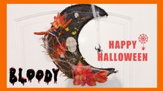 a happy halloween card with a wreath on the front door and an image of a half moon