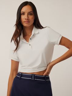 The Cropped Scarlett Polo is designed to elevate every aspect of your life. Designed with an athletic cropped fit to provide high performance and comfort. Featuring a signature knit collar with contrast tipping and a three-button placket. Finished with ribbed cuffs and hem band. Athleisure Sports Top With Polo Collar, Sporty Stretch Tops For Work, Fitted Sports Top With Polo Collar, Sports Polo Collar Fitted Top, Sporty Cropped Top With Ribbed Collar, White Activewear With Contrast Trim For Sports, Sporty Stretch Tops With Contrast Trim, Fitted Athleisure Tops For Workwear, White Sporty Tops With Ribbed Waistband