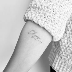 a woman's arm with the word love tattooed on it